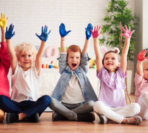 Group of children with colorful, painted hands