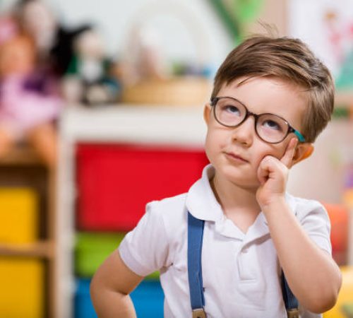 Little boy planning in classroom.
